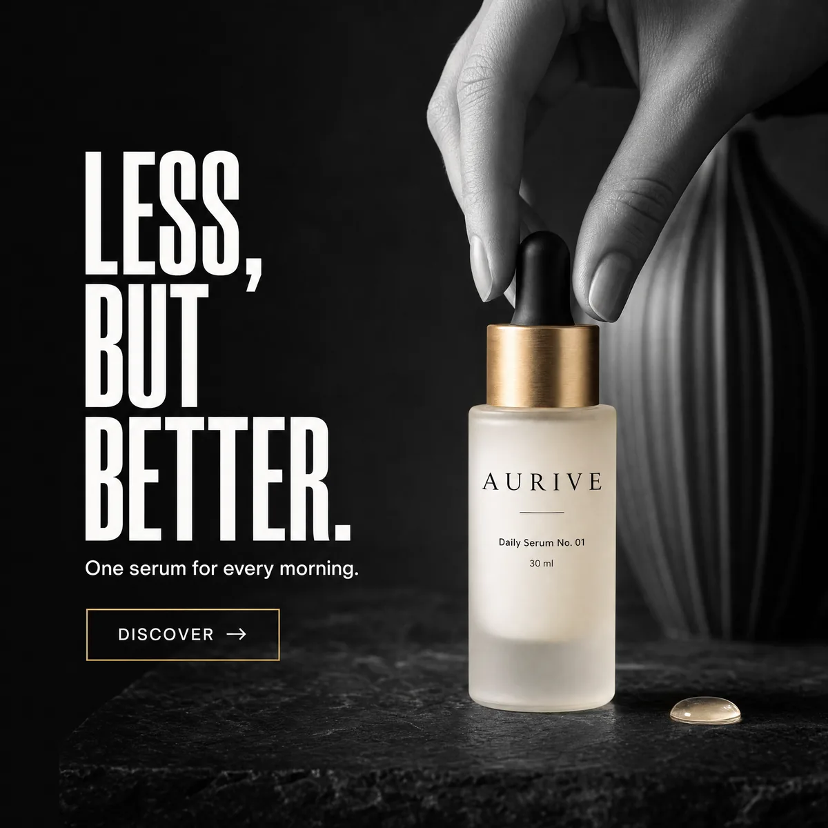 A black-and-white hand lifts the dropper of the only object in colour, a frosted Aurive serum bottle with a gold collar.
